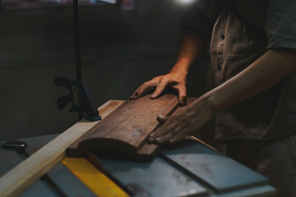 Carpenter shaping wood at a workbench