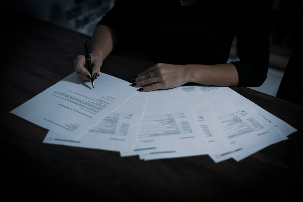 Business owner writing on paperwork at a table