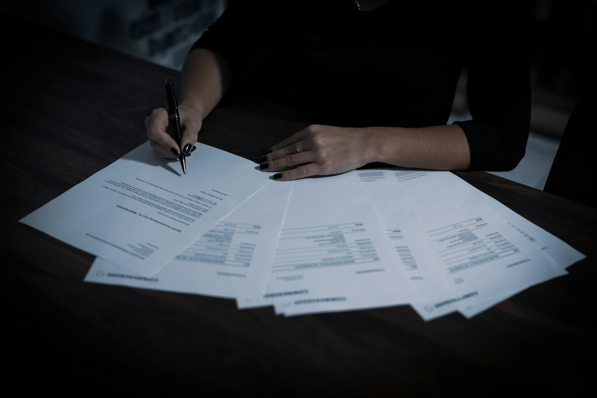 Business owner writing on paperwork at a table